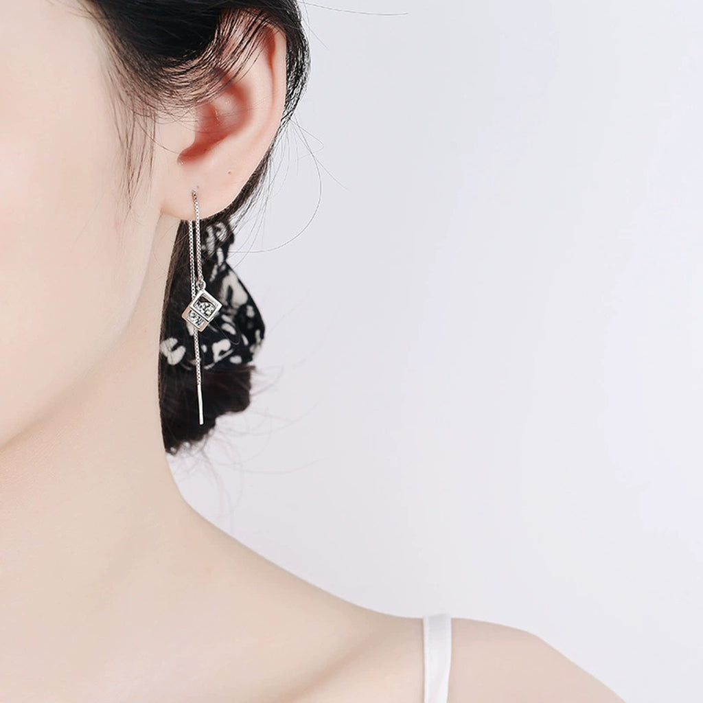 Round Moissanite Threader Drop Earrings in Rhodium-Plated S925 sterling silver worn on ear by model showing scale, placement, and threader drop earrings styling