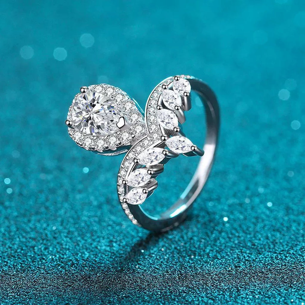 Pear Cut Moissanite Side Stone Engagement Ring with CZ product view showing moissanite setting and metal finish