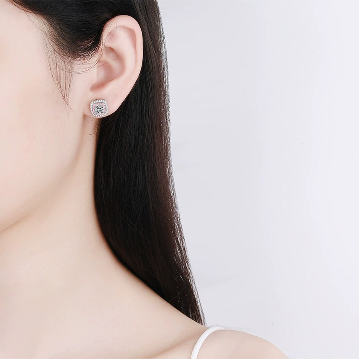 Pink CZ Halo Moissanite Stud Earrings in Rhodium-Plated S925 sterling silver worn on ear by model showing scale, placement, and stud earrings styling