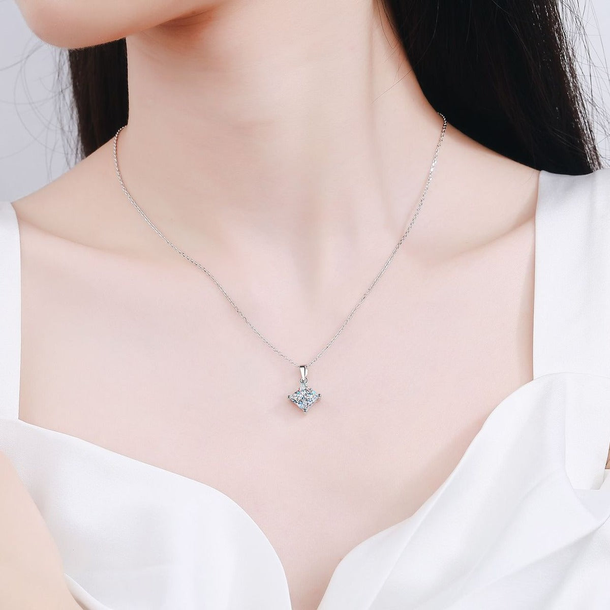 Princess Cut Moissanite Pendant Necklace in Rhodium-Plated S925 sterling silver worn on neckline by model showing scale and adjustable chain styling