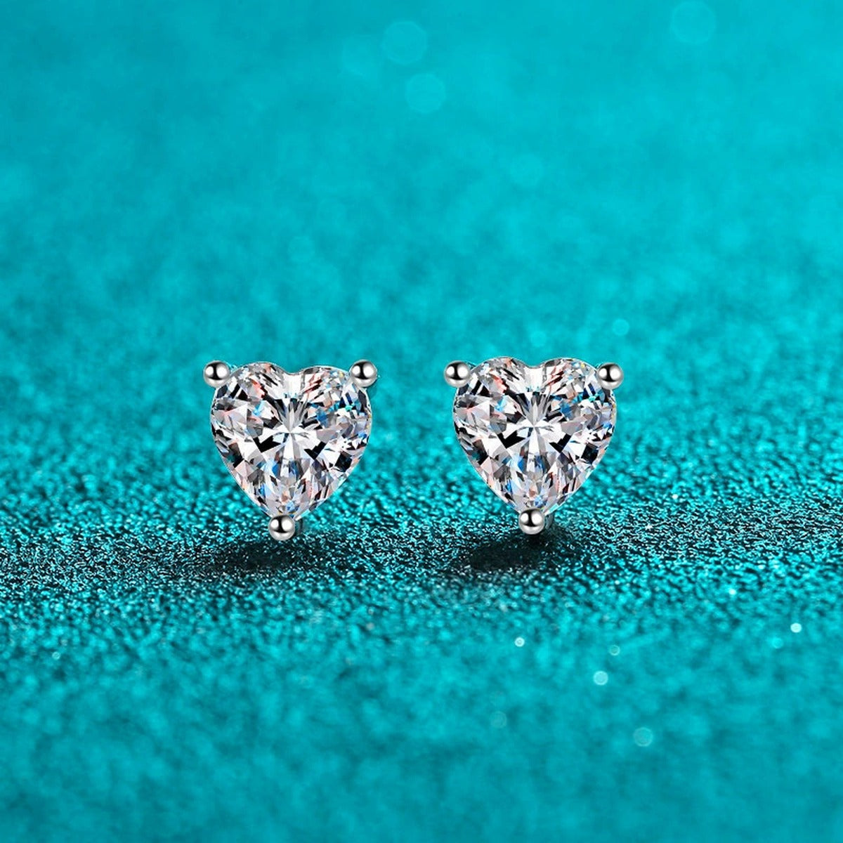Heart Cut Moissanite Stud Earrings in Rhodium-Plated S925 sterling silver product scene view showing front sparkle