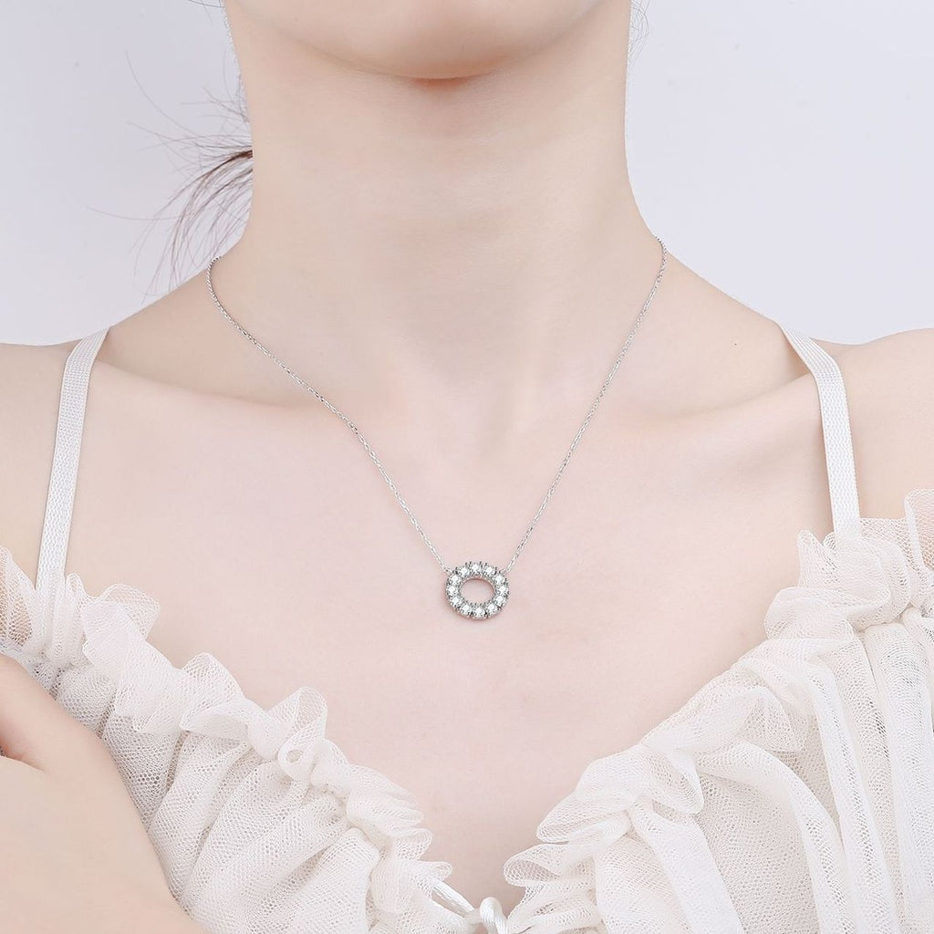 Circle Moissanite Pendant Necklace in Rhodium-Plated S925 sterling silver worn on neckline by model showing scale and adjustable chain styling