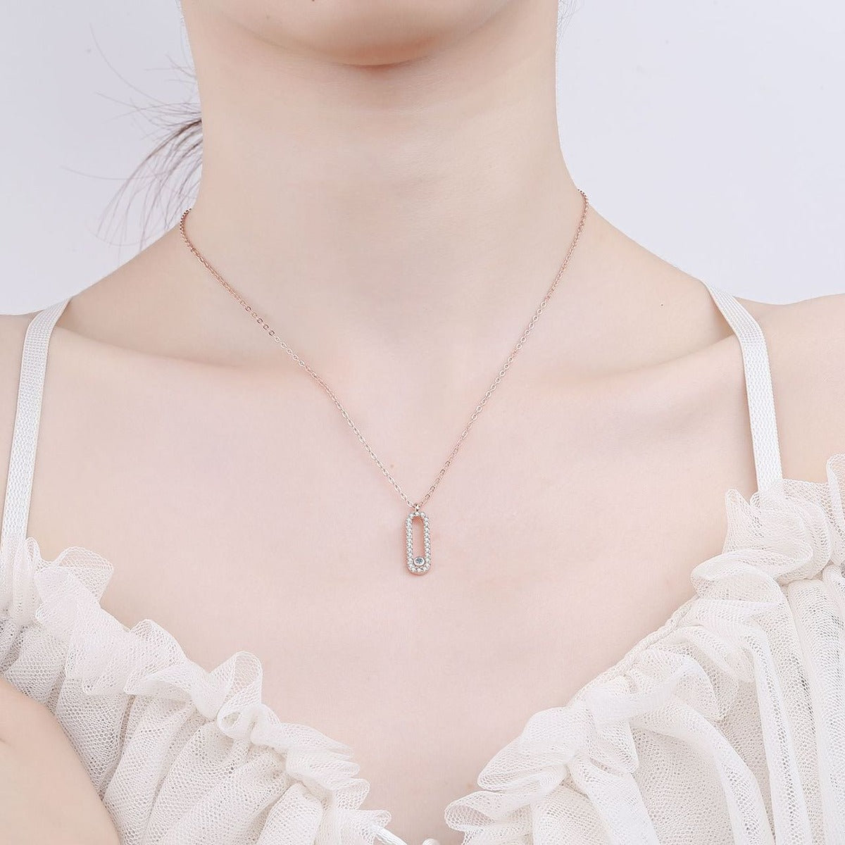 Geometric Lock Moissanite Pendant Necklace in Rhodium and Rose Gold-Plated S925 sterling silver worn on neckline by model showing scale and adjustable chain styling
