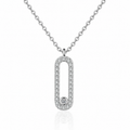A silver-toned oval pendant necklace with a border of small clear stones and a single round stone at the bottom, shown on a white background with a faint reflection.
