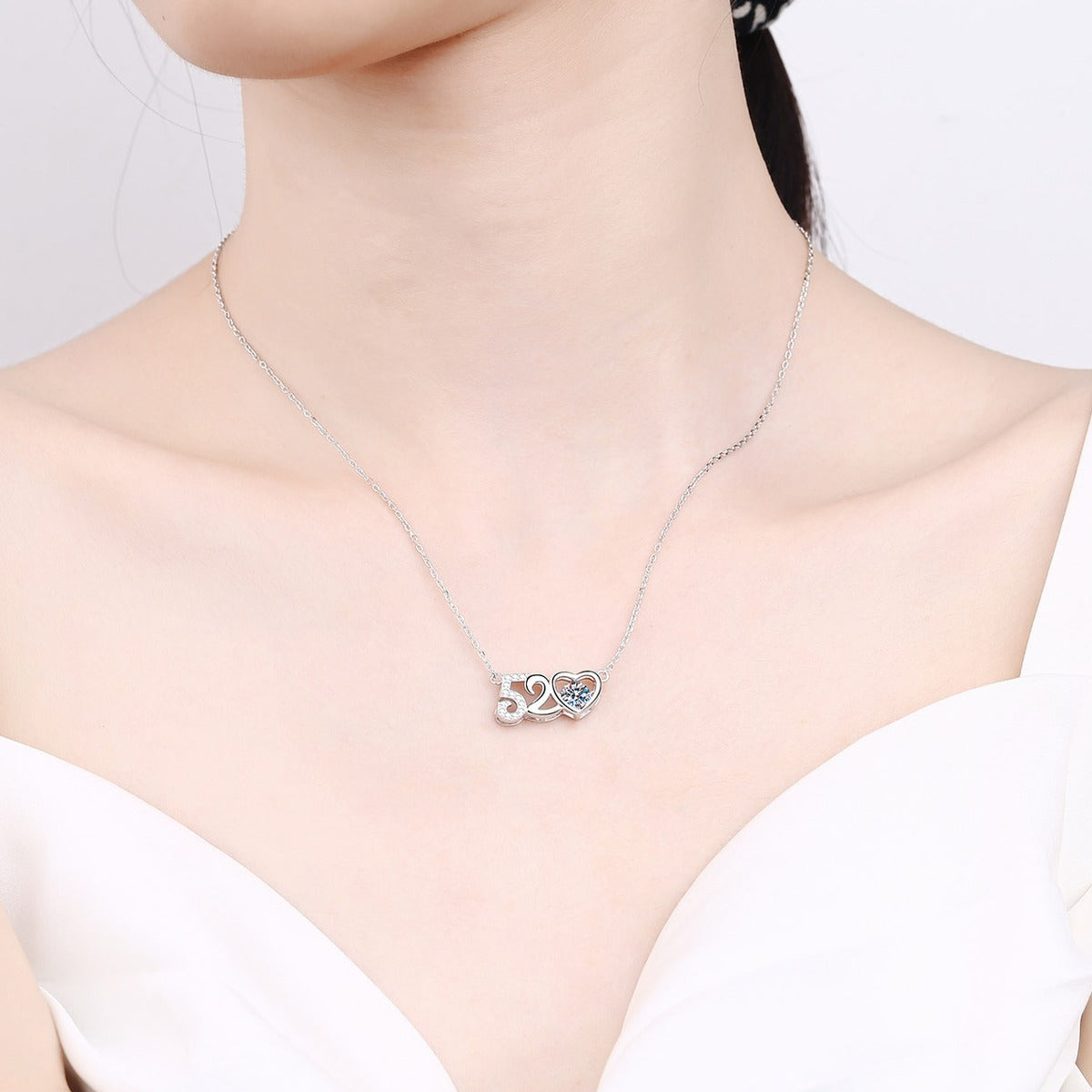Heart Moissanite Pendant Necklace with CZ in Rhodium-Plated S925 sterling silver worn on neckline by model showing scale and adjustable chain styling