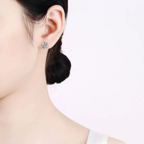 Bezel Round Moissanite Stud Earrings in Rhodium-Plated S925 sterling silver worn on ear by model showing scale, placement, and stud earrings styling