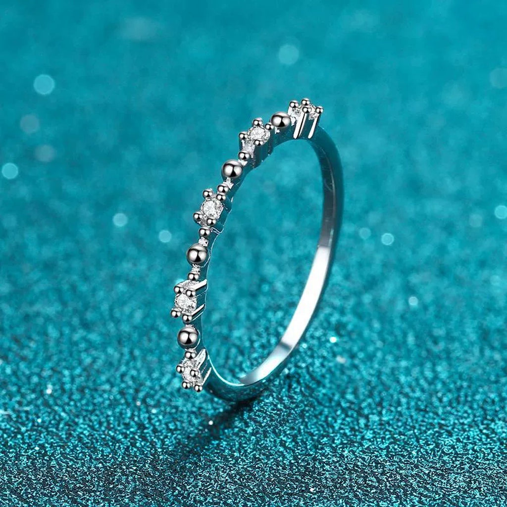 Delicate Round Moissanite Band Ring product view showing moissanite setting and rhodium finish
