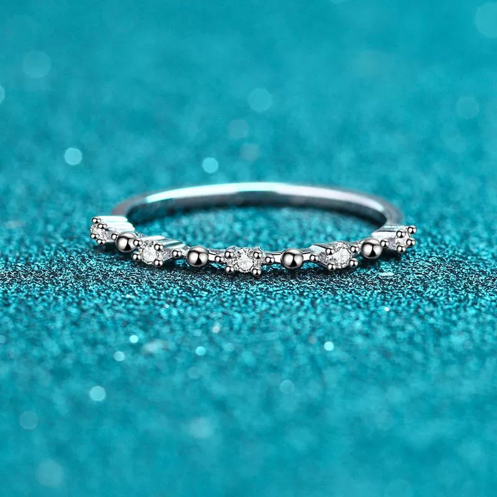 Delicate Round Moissanite Band Ring product view showing moissanite setting and rhodium finish