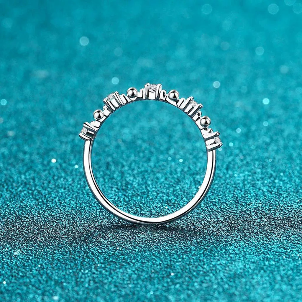Delicate Round Moissanite Band Ring product view showing moissanite setting and rhodium finish