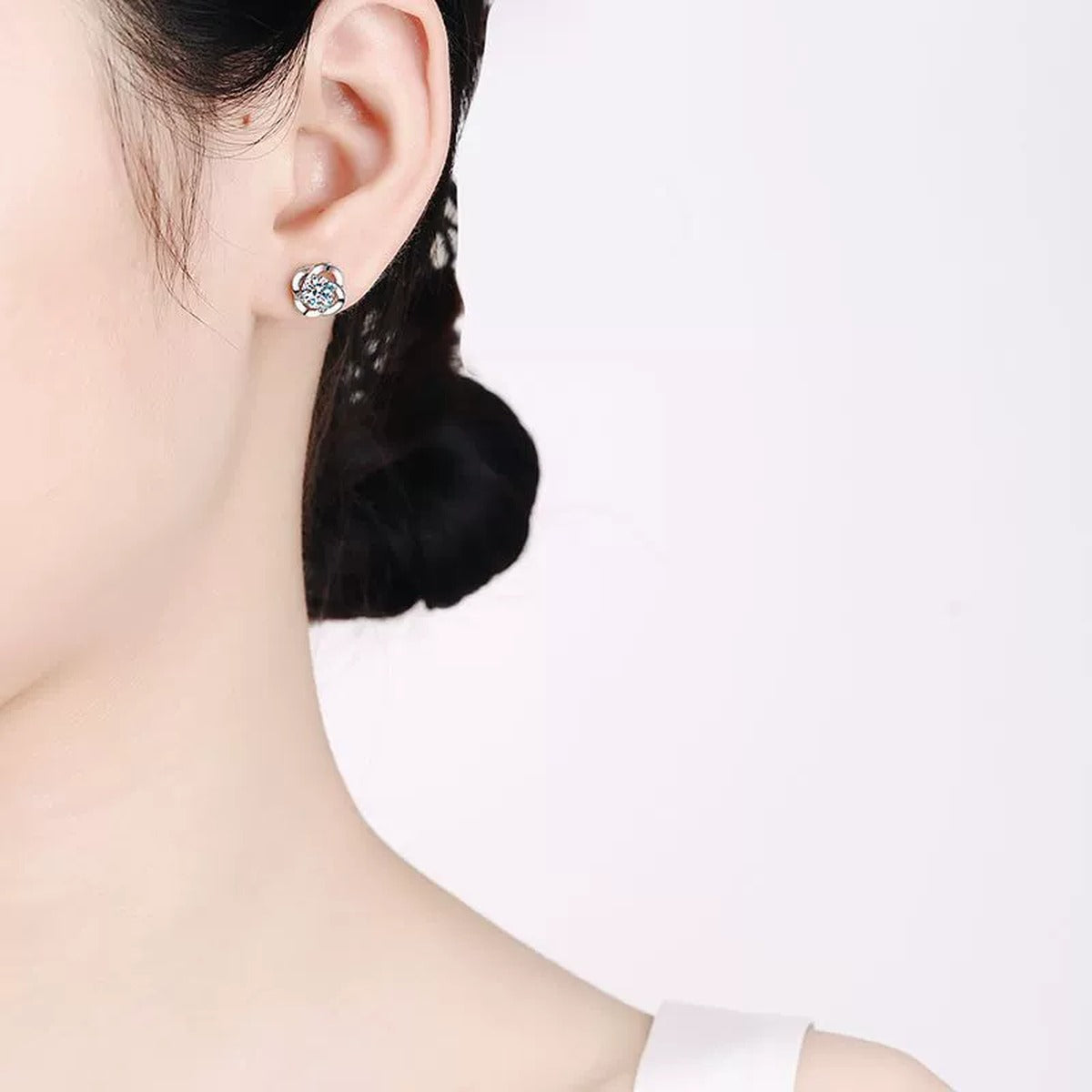 Floral Round Moissanite Stud Earrings in Rhodium-Plated S925 sterling silver worn on ear by model showing scale, placement, and stud earrings styling