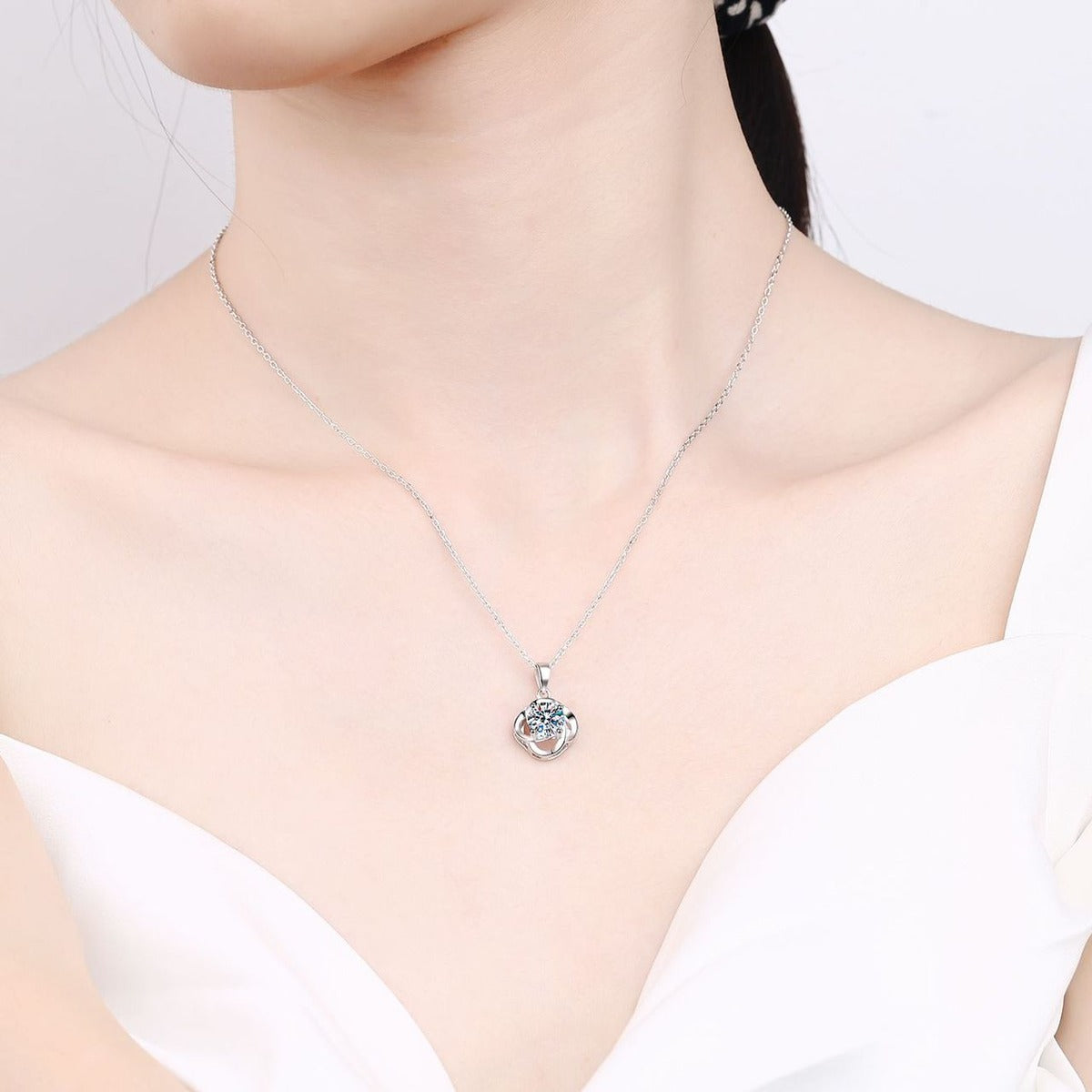 Round Moissanite Pendant Necklace in Rhodium-Plated S925 sterling silver worn on neckline by model showing scale and adjustable chain styling