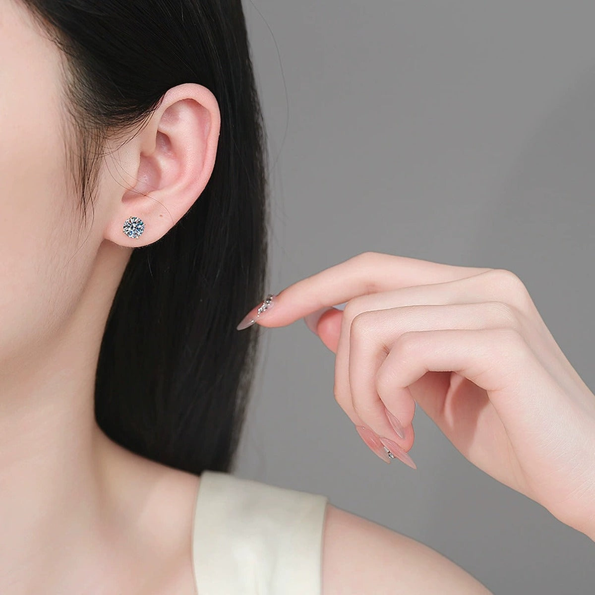 Round Moissanite Stud Earrings in Champion Gold-Plated S925 sterling silver worn on ear by model showing scale, placement, and stud earrings styling