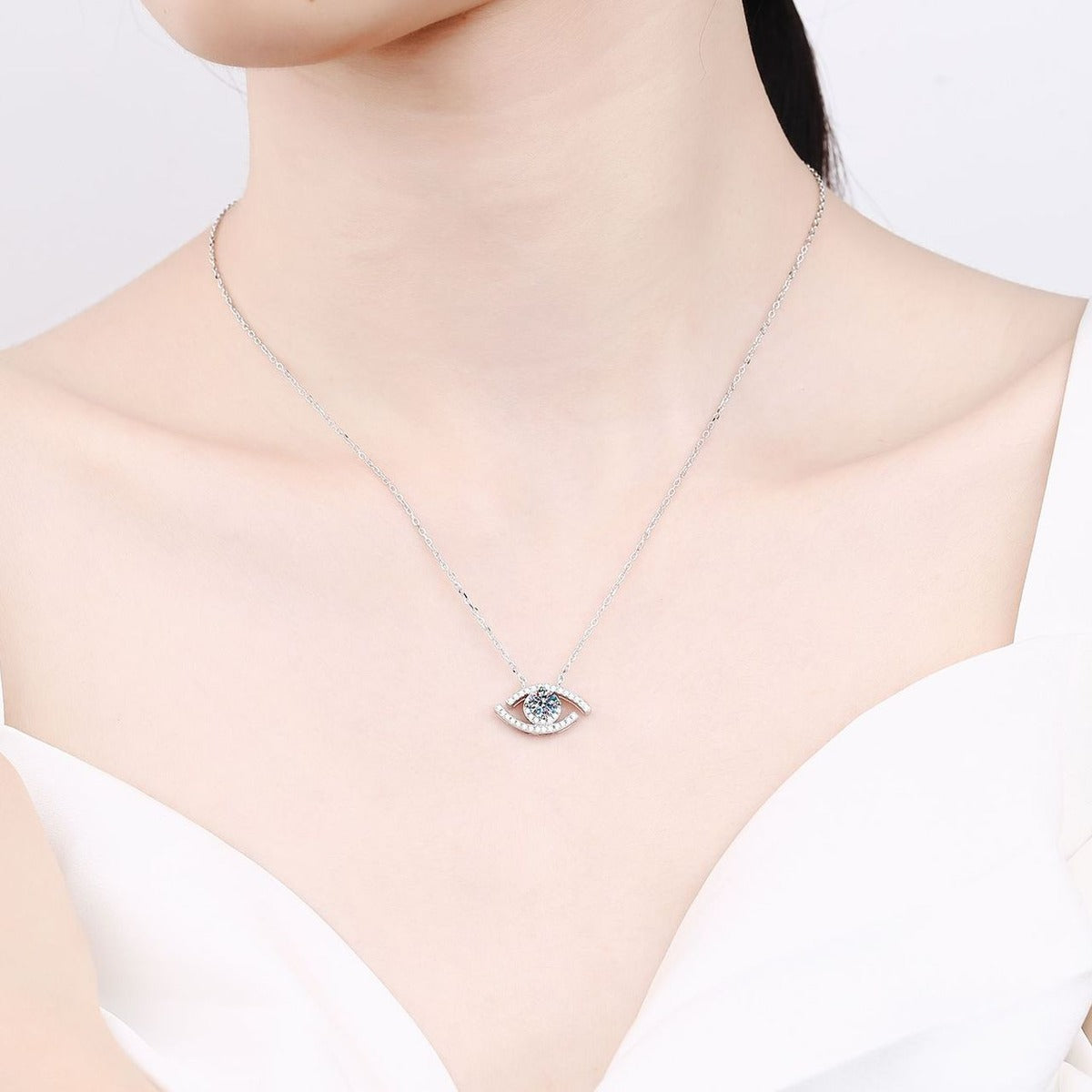 All-Seeing Eye Moissanite Pendant Necklace with CZ in Rhodium-Plated S925 sterling silver worn on neckline by model showing scale and adjustable chain styling