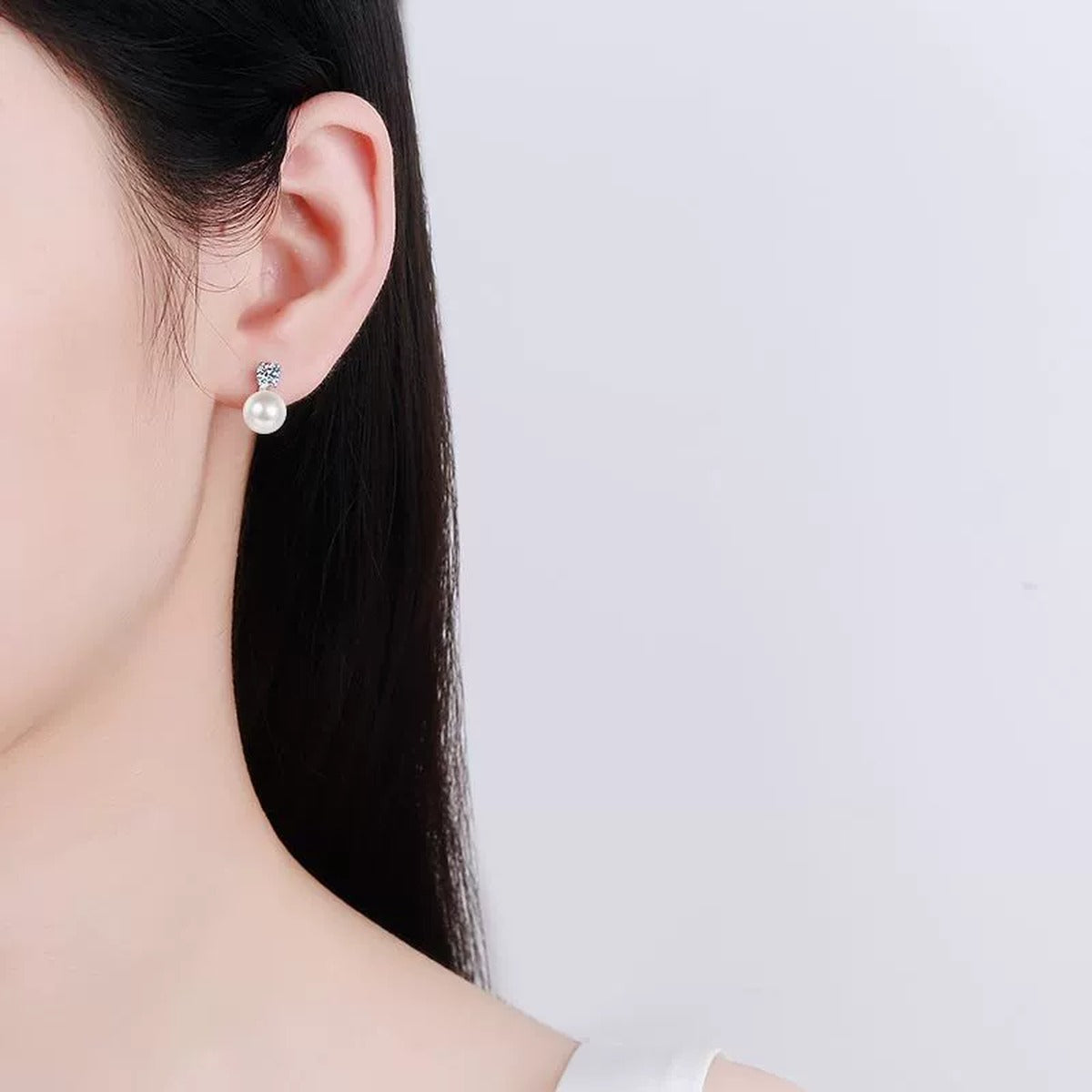 Square Cluster Moissanite Pearl Stud Drop Earrings in Rhodium-Plated S925 sterling silver worn on ear by model showing scale, placement, and stud earrings styling