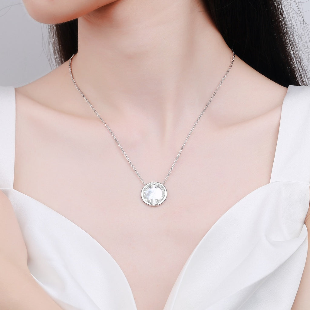 Mother-of-Pearl Disc Pendant Necklace in Rhodium-Plated S925 sterling silver worn on neckline by model showing scale and adjustable chain styling