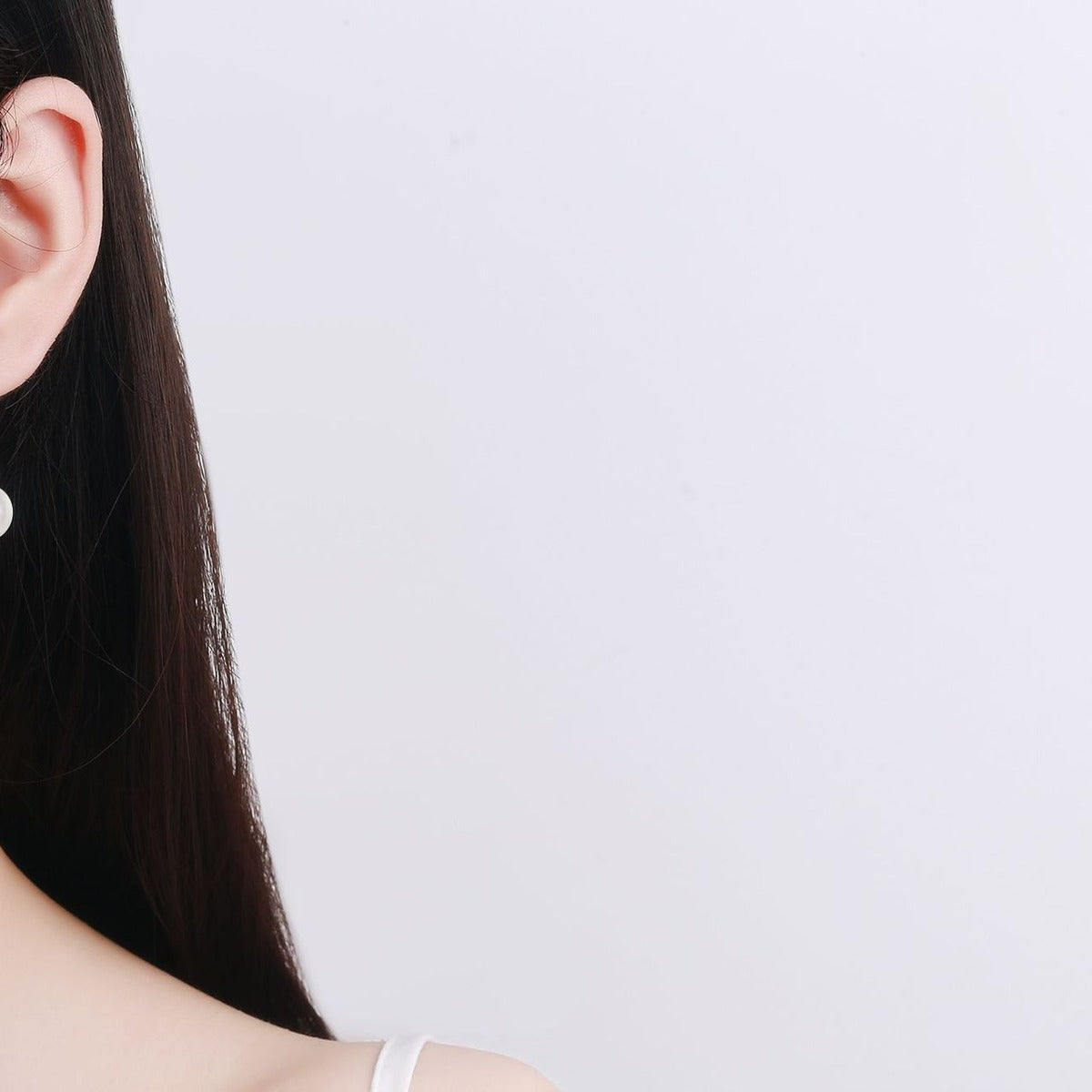 Moissanite Pearl Hook Dangle Earrings in Rhodium-Plated S925 sterling silver worn on ear by model showing scale, placement, and hook dangle earrings styling