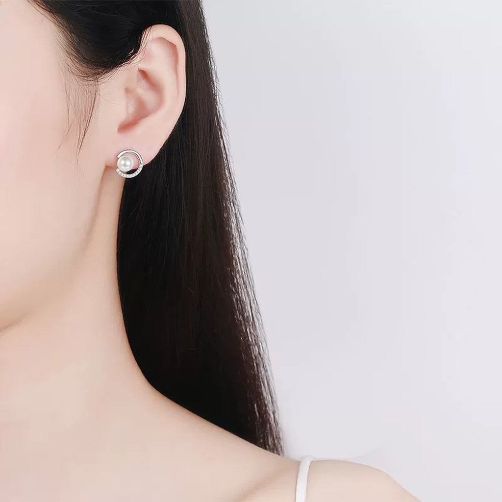 Crescent Pearl Moissanite Stud Earrings in Rhodium-Plated S925 sterling silver worn on ear by model showing scale, placement, and stud earrings styling