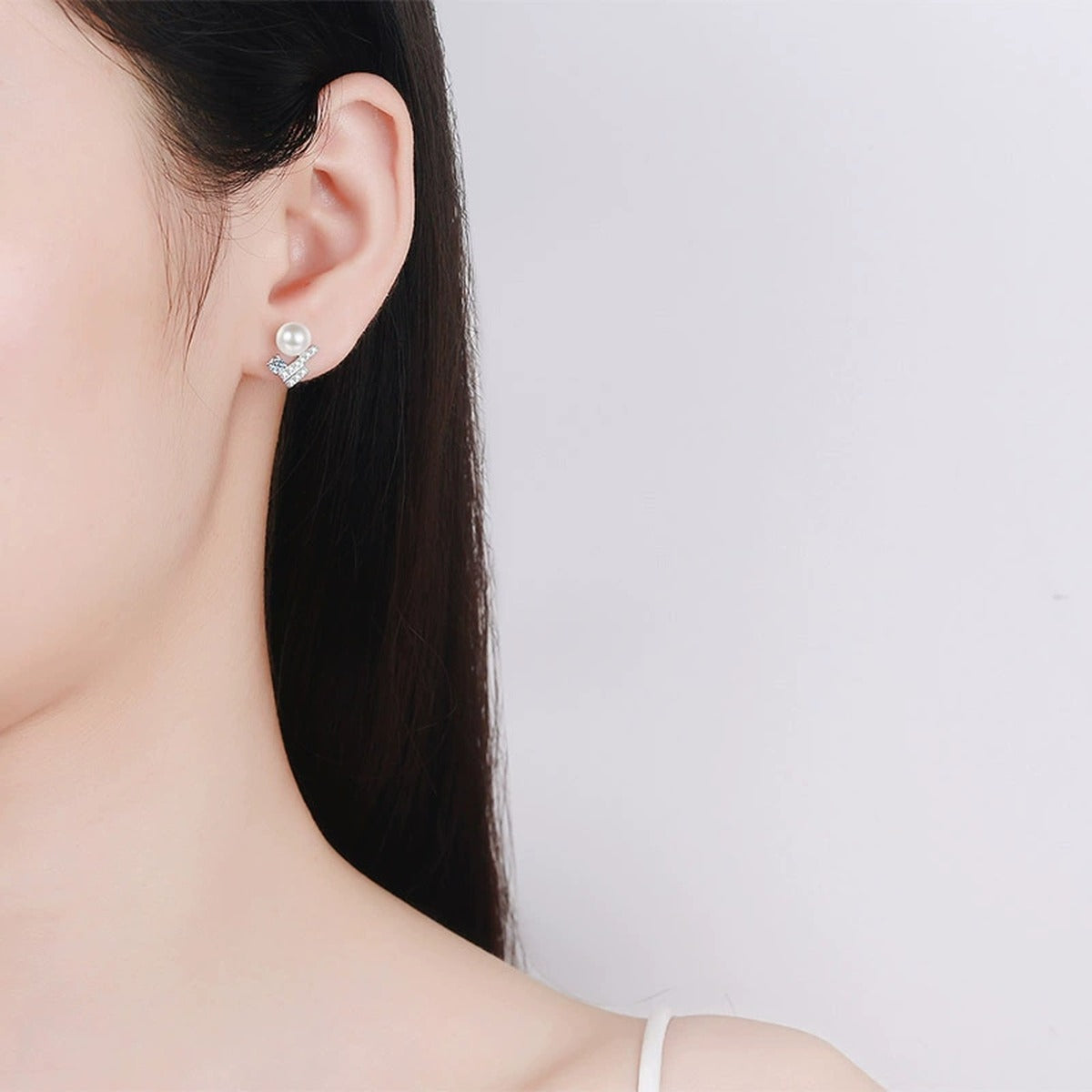 Pearl Bar Moissanite Stud Earrings in Rhodium-Plated S925 sterling silver worn on ear by model showing scale, placement, and stud earrings styling