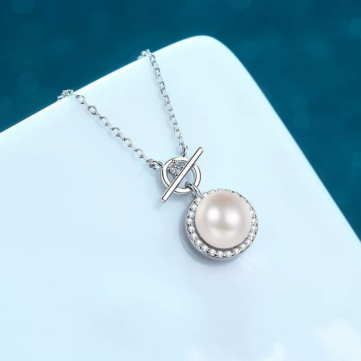 Halo Moissanite Pearl Pendant Necklace in Rhodium-Plated S925 sterling silver blue display scene showing chain and stone layout