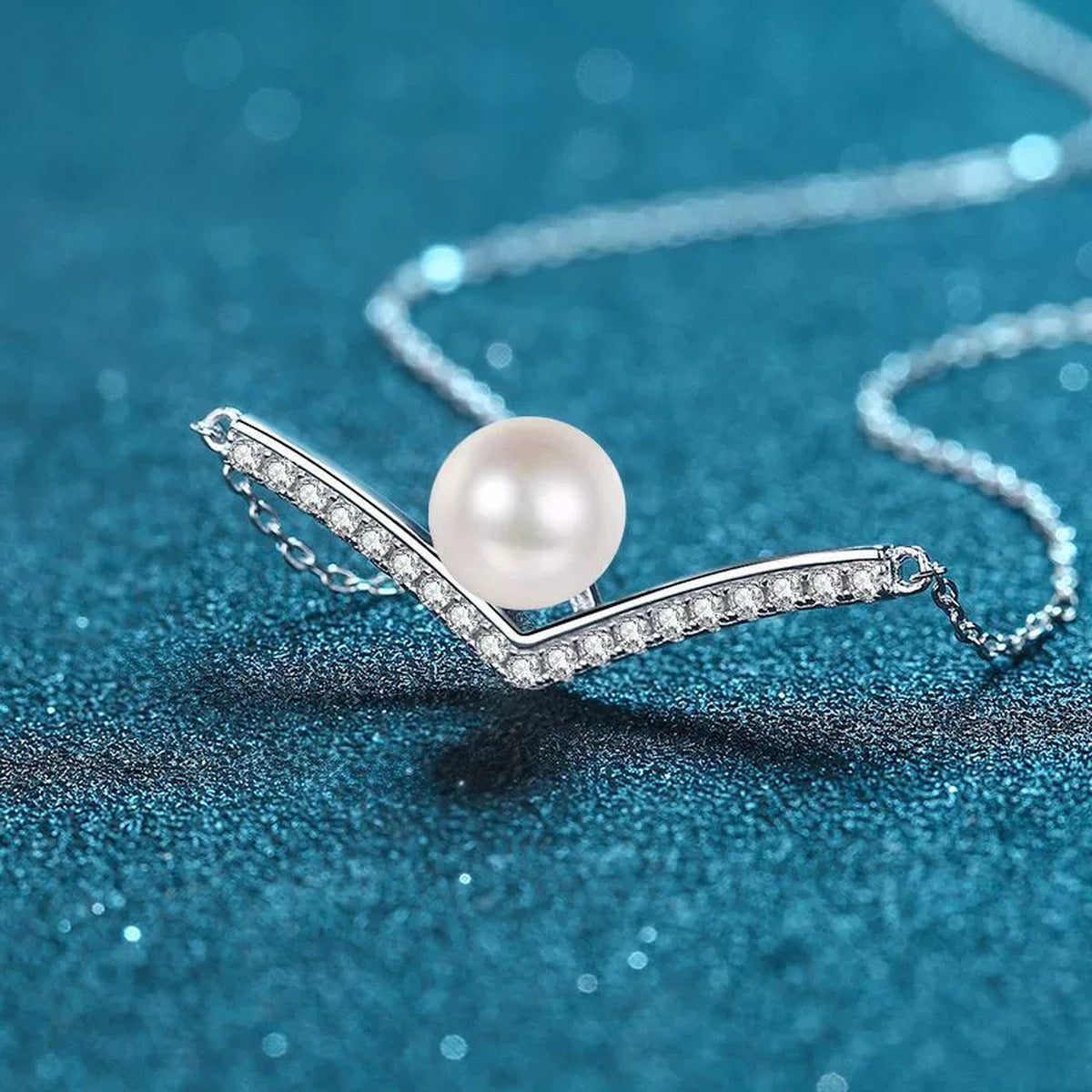 V Motif Moissanite Pearl Pendant Necklace in Rhodium-Plated S925 sterling silver blue display scene showing chain and stone layout