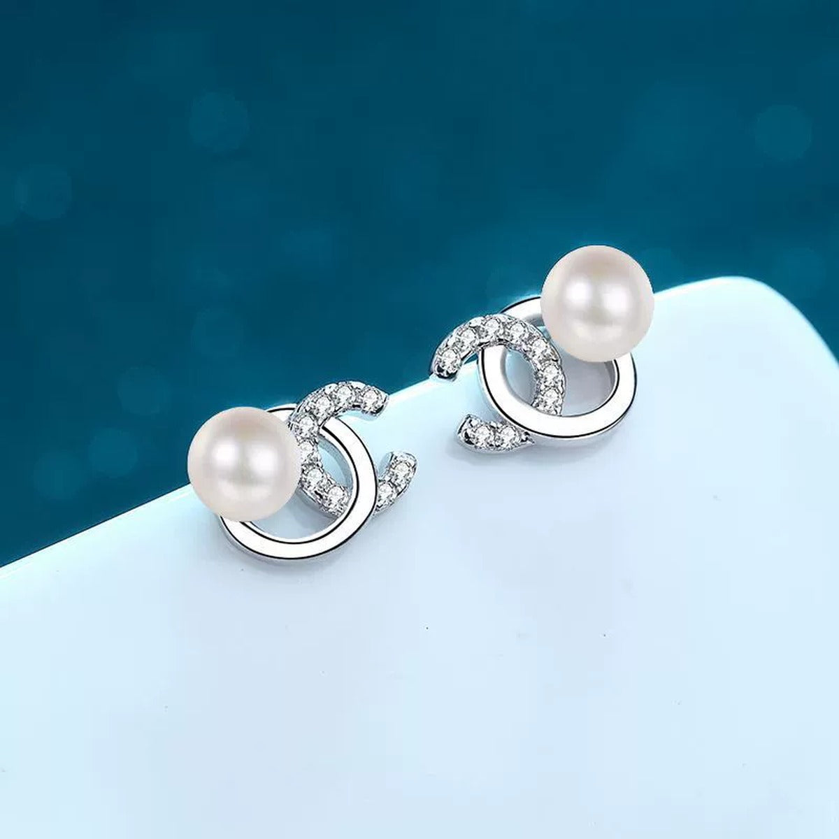 Swirl Pearl Moissanite Stud Earrings in Rhodium-Plated S925 sterling silver product scene view showing front detail