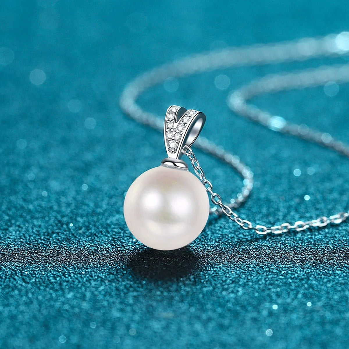 V Motif Moissanite Pearl Pendant Necklace in Rhodium-Plated S925 sterling silver blue display scene showing chain and stone layout