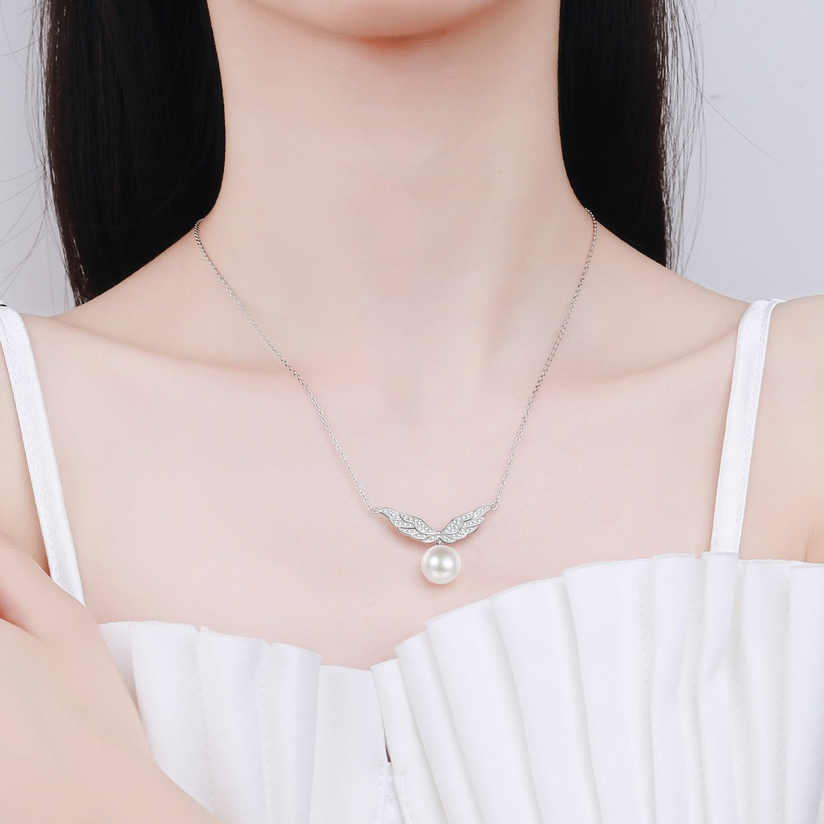 Angel Wing Moissanite Pearl Pendant Necklace in Rhodium-Plated S925 sterling silver neckline model view showing pendant scale and adjustable chain