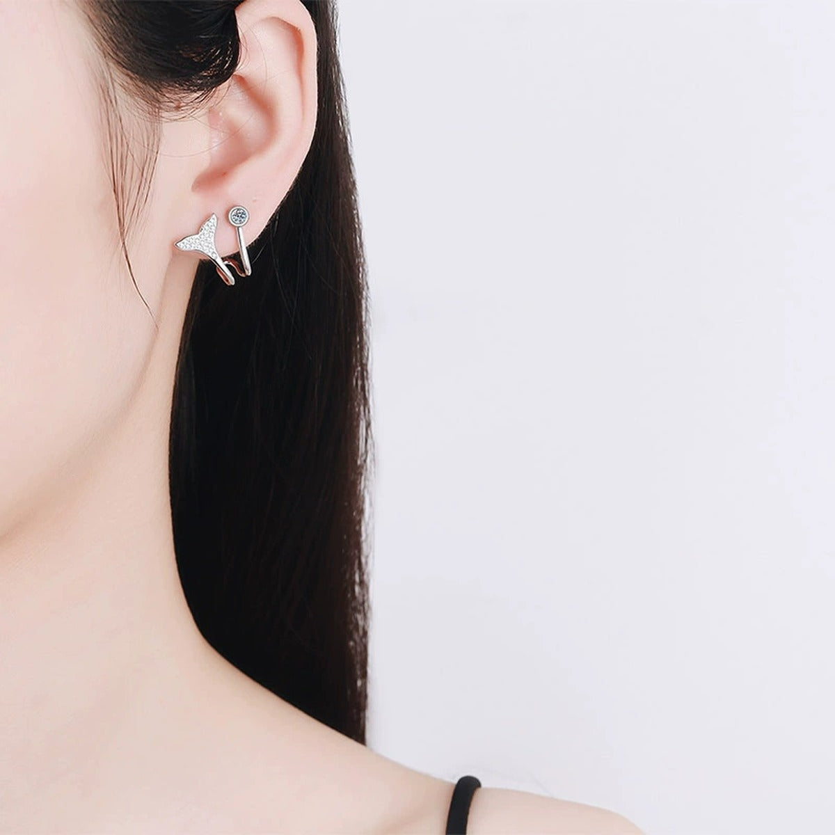 Whale Tail Moissanite Ear Cuff Stud Earrings in Rhodium-Plated S925 sterling silver worn on ear by model showing scale, placement, and ear cuff stud earrings styling