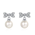 Bow Moissanite Stud Dangle Earrings in Rhodium-Plated S925 sterling silver on white background showing the full pair, pearl and moissanite detail, and stud dangle earrings silhouette
