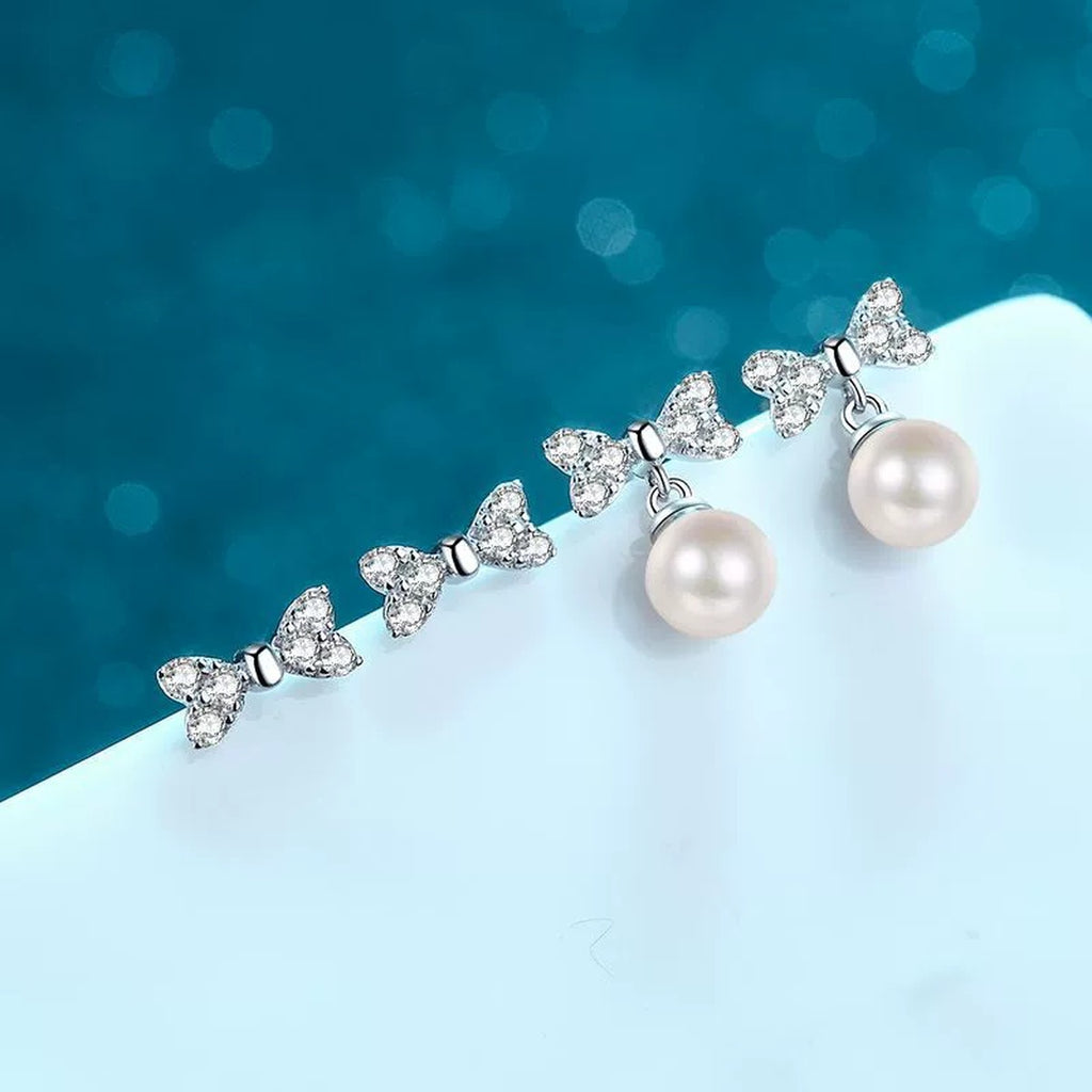Bow Moissanite Stud Dangle Earrings in Rhodium-Plated S925 sterling silver product scene view showing angled setting detail