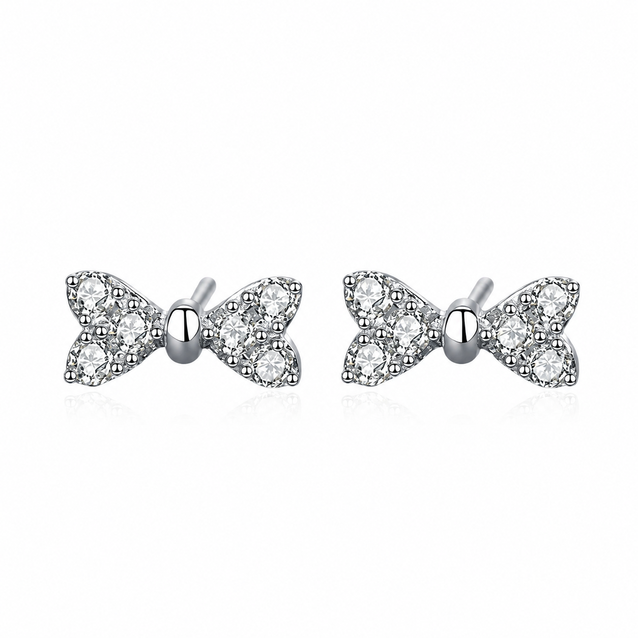 A pair of silver bow stud earrings set with clear round-cut gemstones, displayed on a clean white background with a soft reflection.