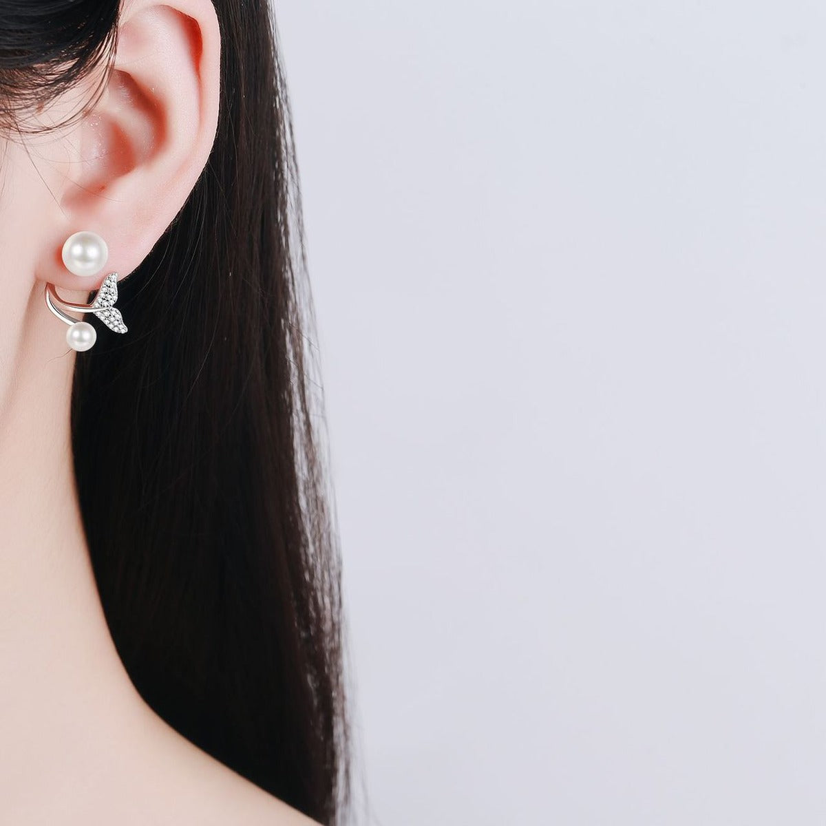 Mermaid Tail Pearl Moissanite Stud Drop Earrings in Rhodium-Plated S925 sterling silver worn on ear by model showing scale, placement, and stud earrings styling