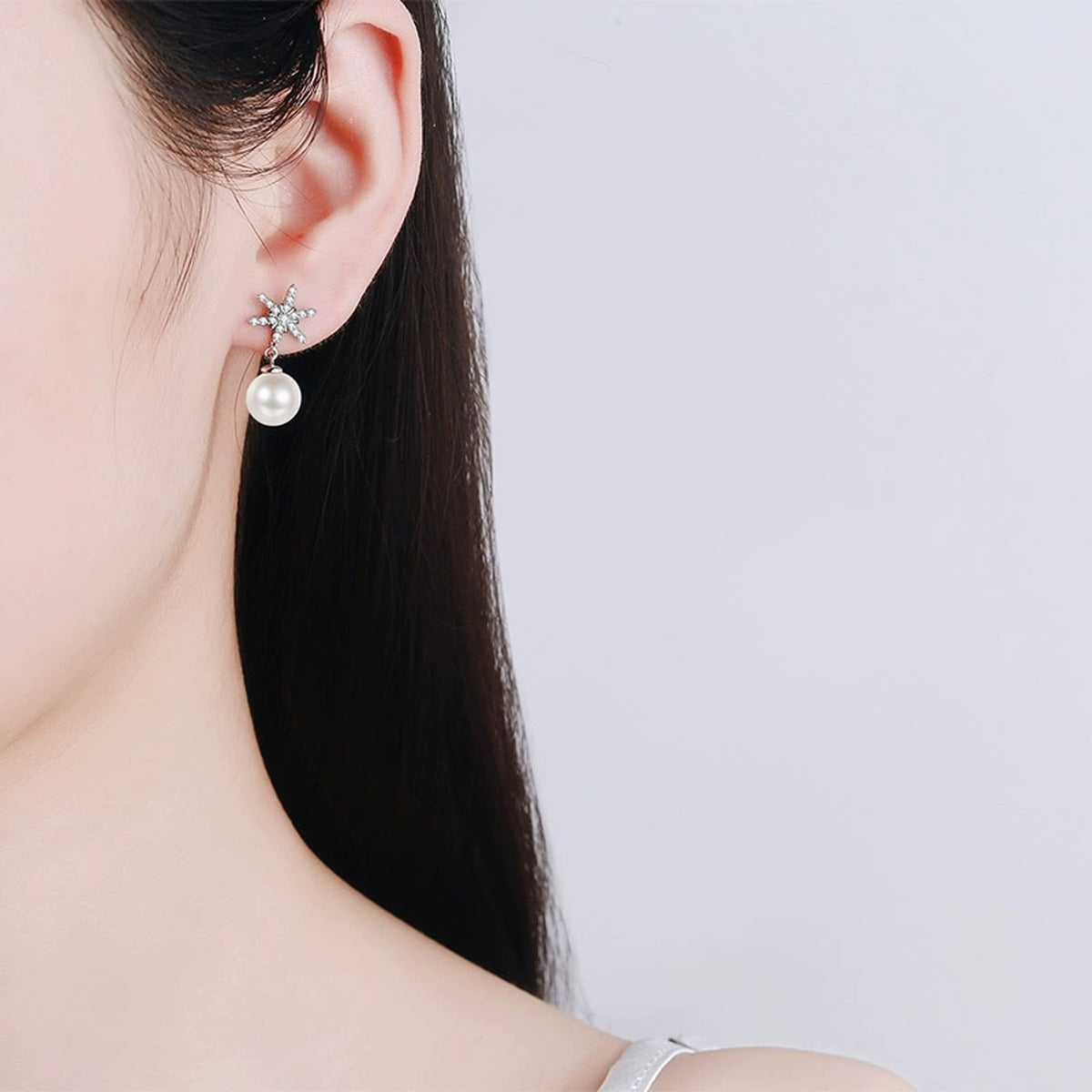 Snowflake Pearl Moissanite Stud Dangle Earrings in Rhodium-Plated S925 sterling silver worn on ear by model showing scale, placement, and stud dangle earrings styling