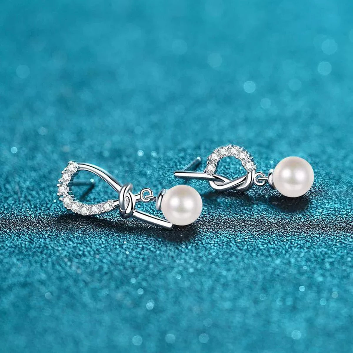 Ribbon Bow Pearl Moissanite Stud Dangle Earrings in Rhodium-Plated S925 sterling silver product scene view showing angled setting detail
