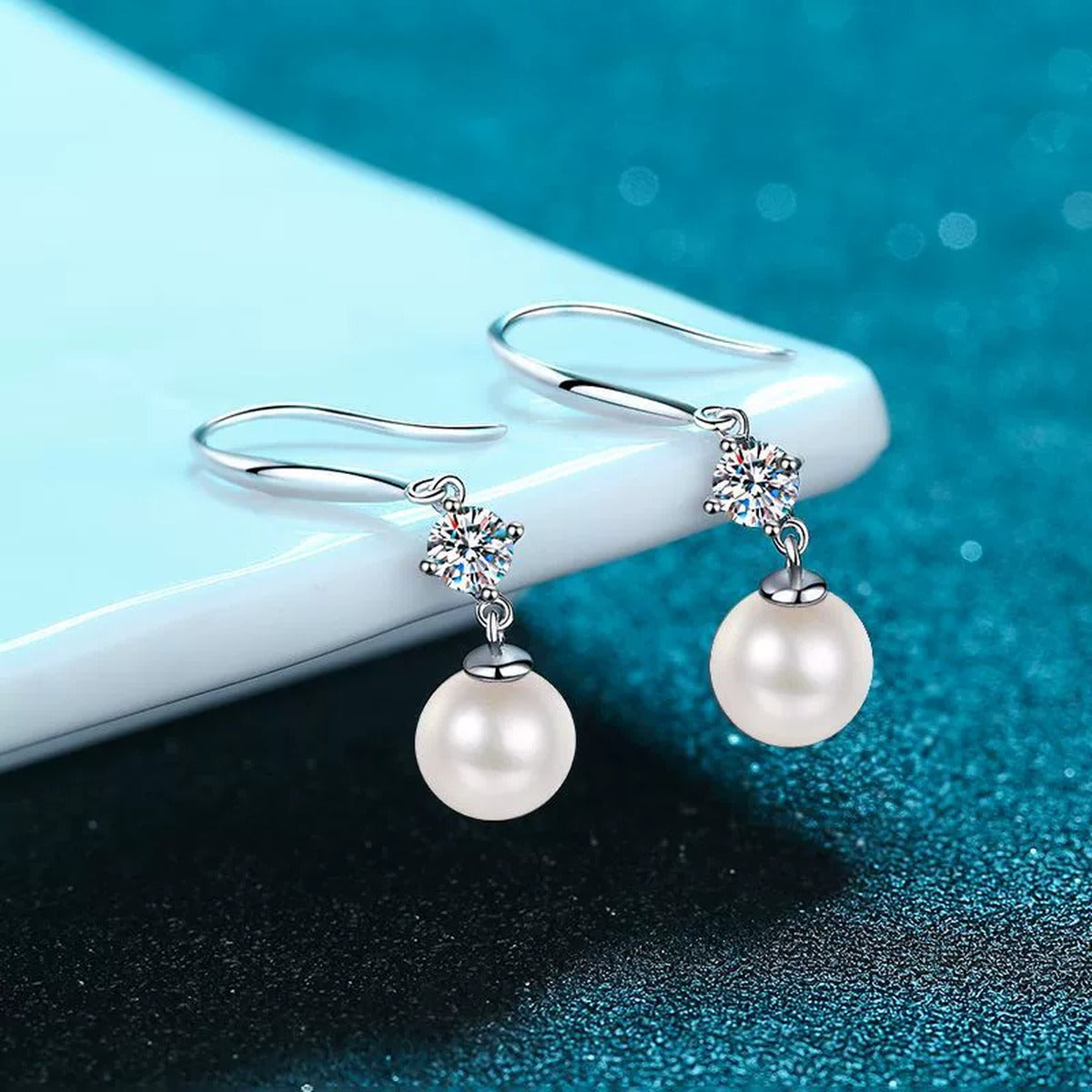 Pearl and Moissanite Hook Dangle Earrings in Rhodium-Plated S925 sterling silver product scene view showing angled setting detail