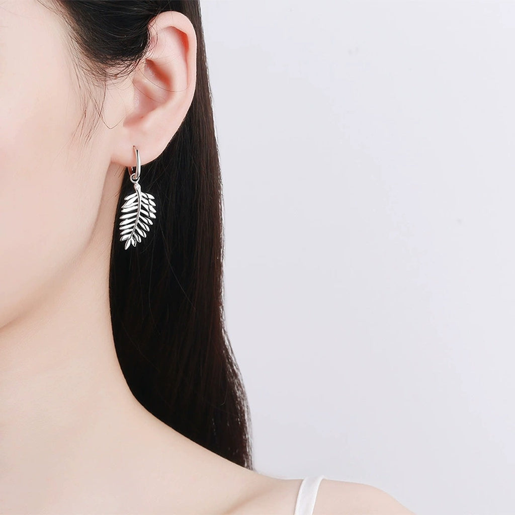 Feather Moissanite Hoop Dangle Earrings in Rhodium-Plated S925 sterling silver worn on ear by model showing scale, placement, and dangle earrings styling