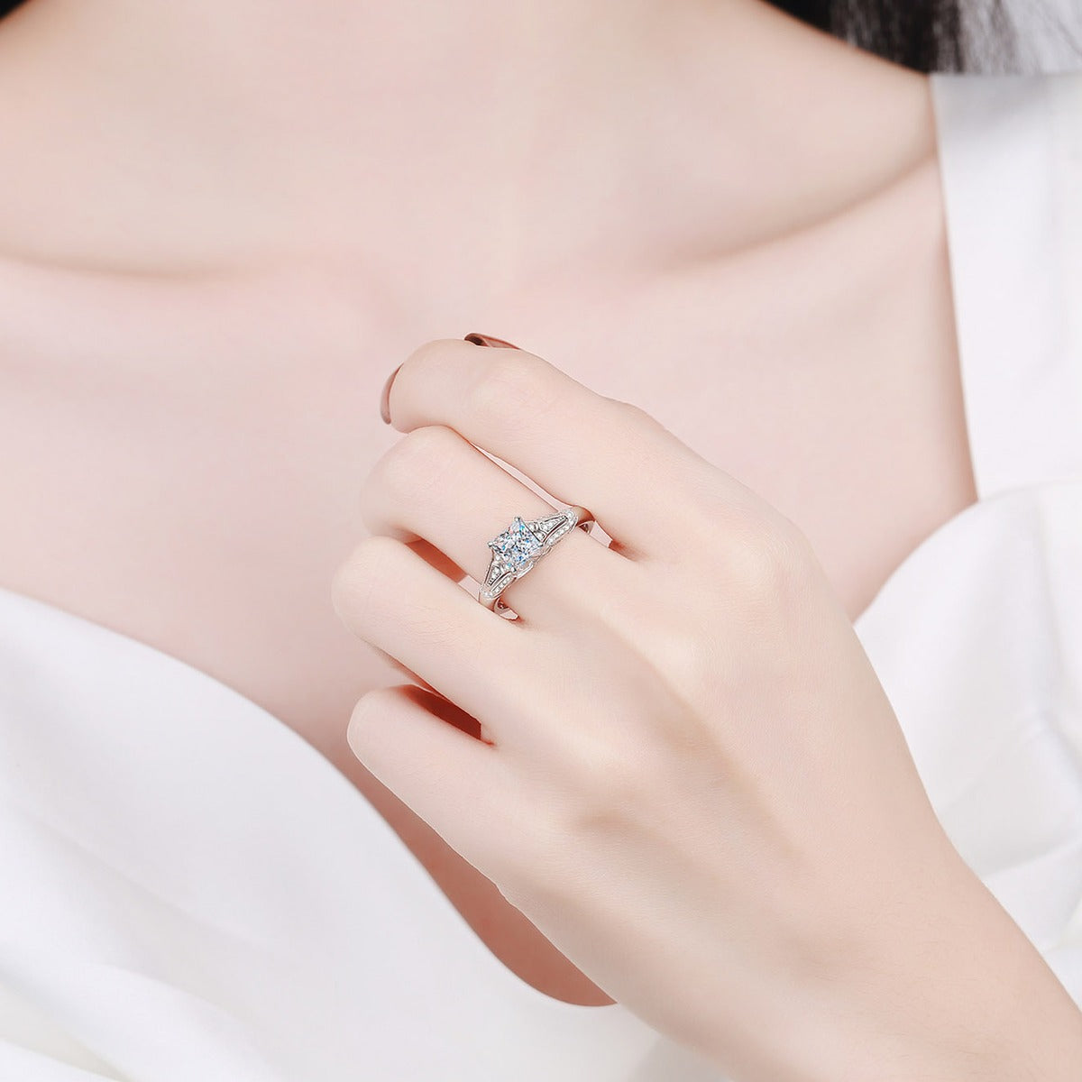 Princess Cut Moissanite Side Stone Ring with CZ worn on hand to show scale, band width, and ring profile