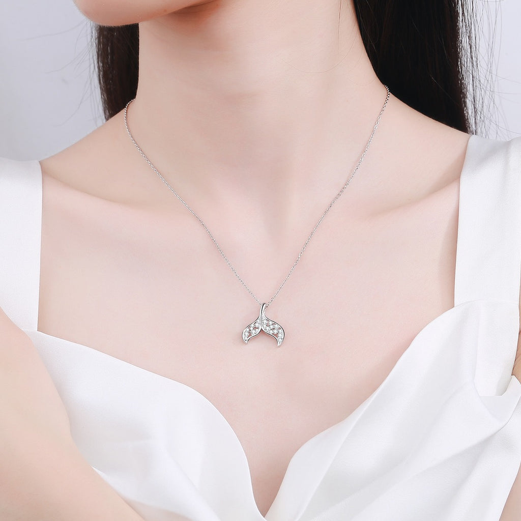Whale Tail Moissanite Pendant Necklace in Rhodium-Plated S925 sterling silver worn on neckline by model showing scale and adjustable chain styling