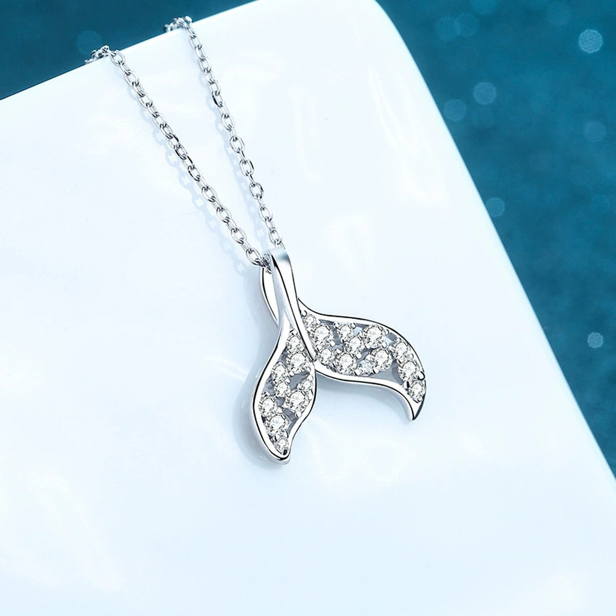 Whale Tail Moissanite Pendant Necklace in Rhodium-Plated S925 sterling silver product scene view showing angled sparkle