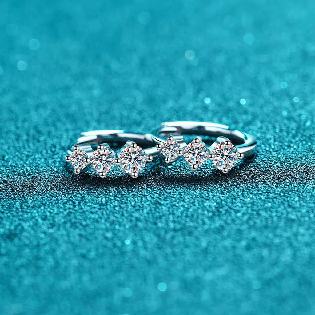 Graduated Moissanite Huggie Hoop Earrings in Rhodium-Plated S925 sterling silver product scene view showing angled setting detail