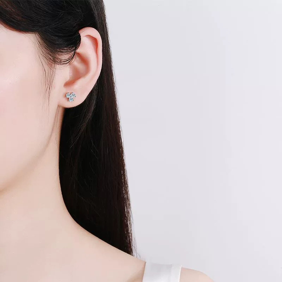 Cluster Round Moissanite Stud Earrings in Rhodium-Plated S925 sterling silver worn on ear by model showing scale, placement, and stud earrings styling