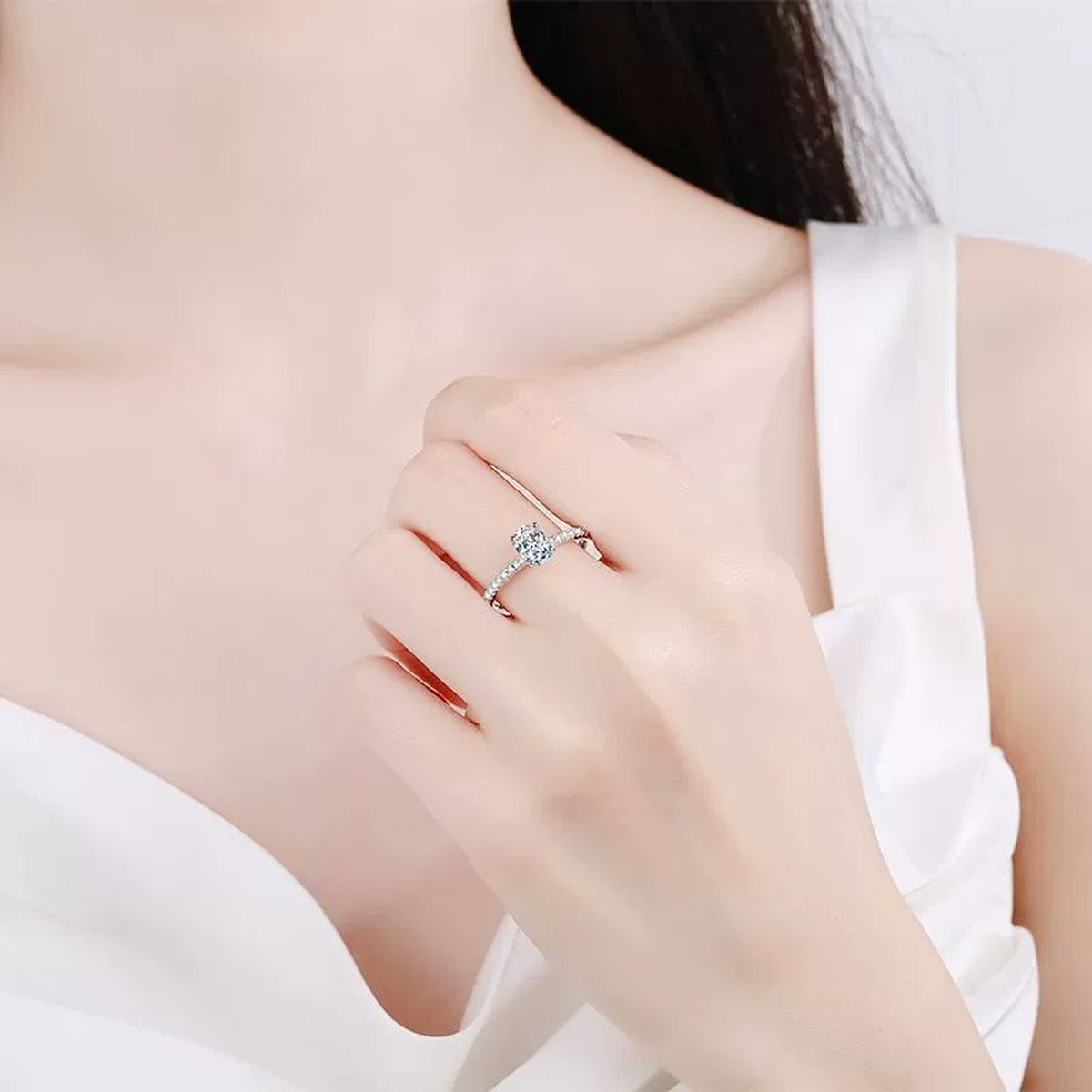 Oval Cut Moissanite Ring with CZ worn on hand to show scale and ring profile