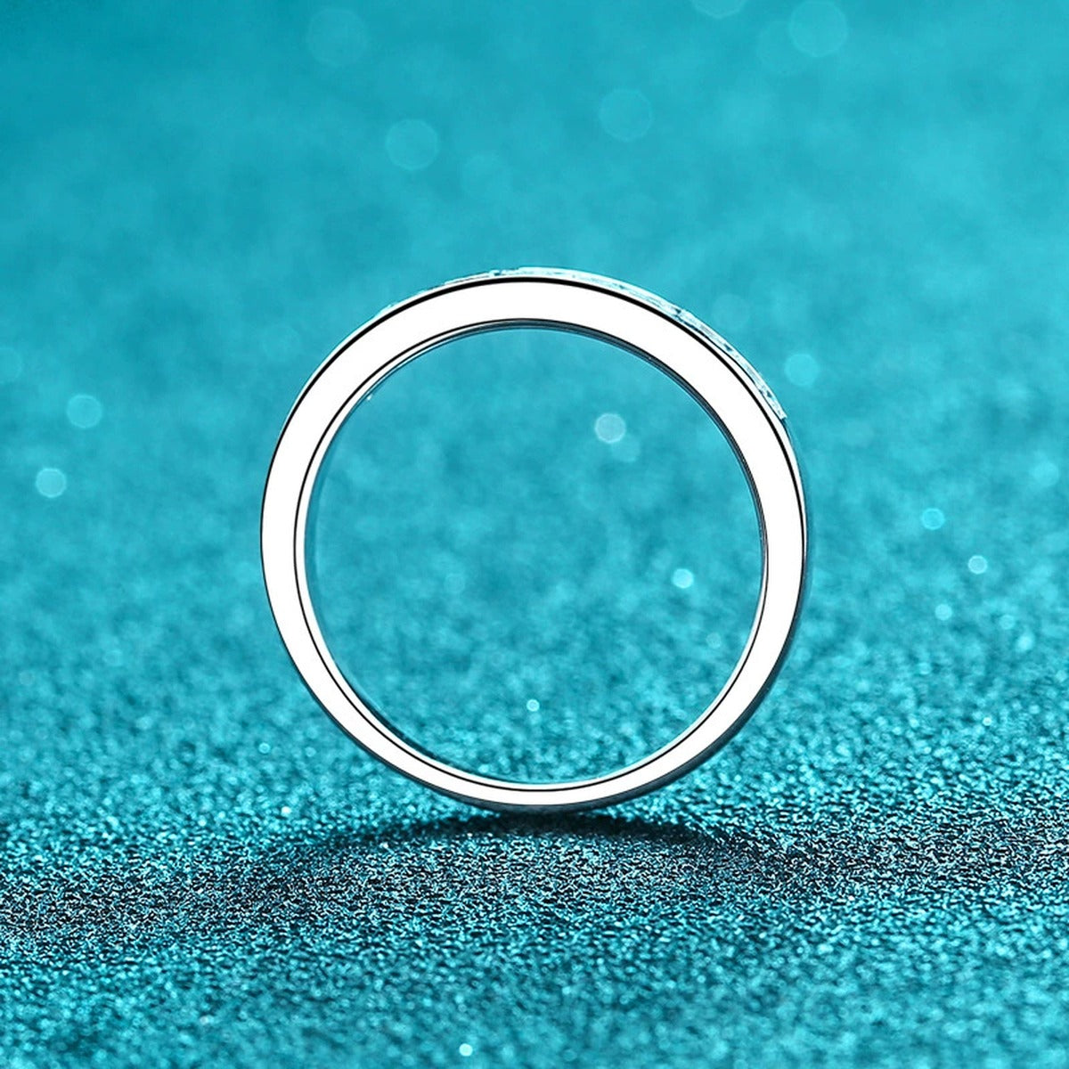Round Moissanite Twist Ring product view showing moissanite setting and rhodium finish