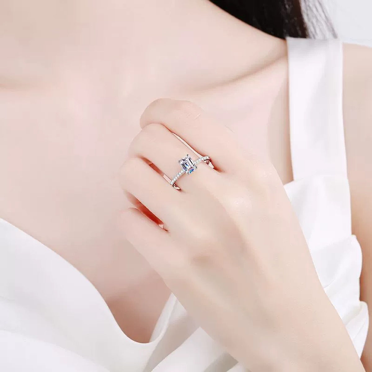 Emerald and Radiant Cut Moissanite Ring with CZ worn on hand to show scale and ring profile