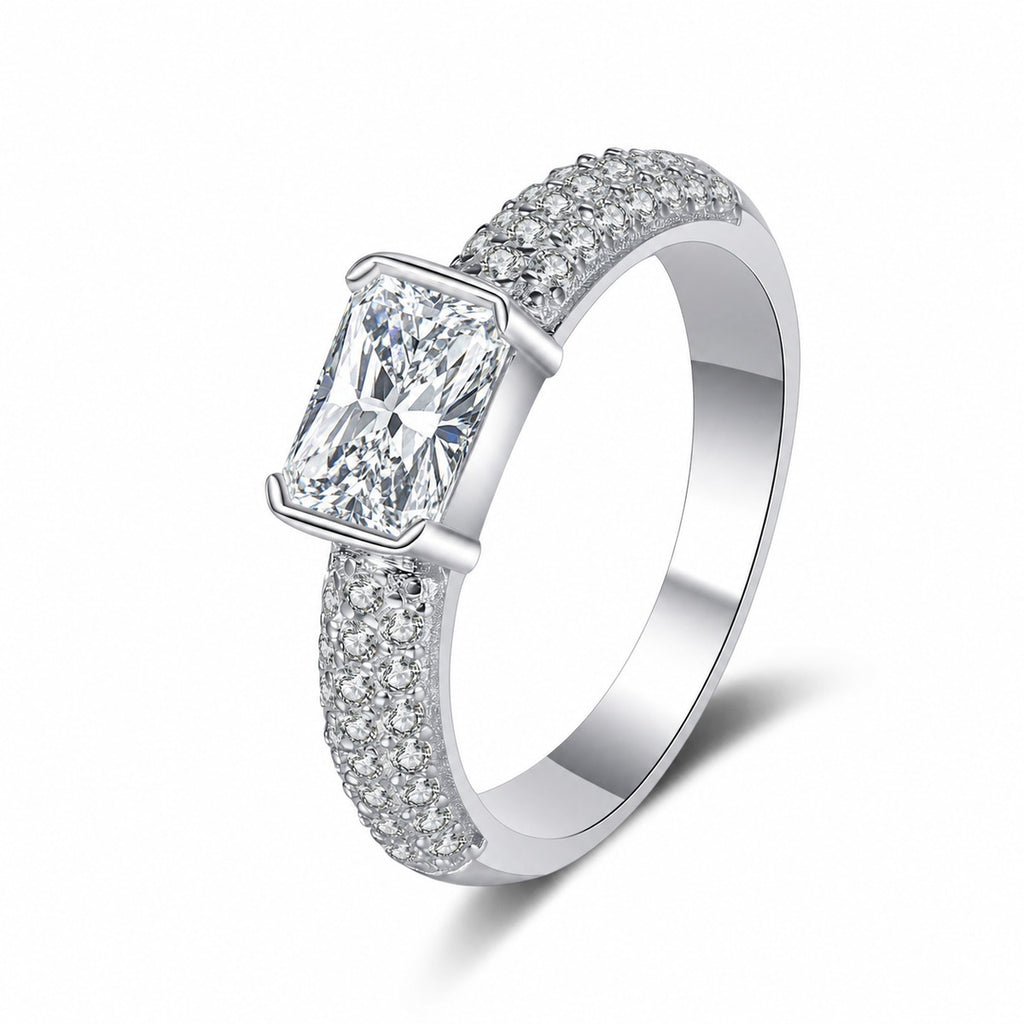 Emerald and Radiant Cut Moissanite Side Stone Engagement Ring with CZ in rhodium-plated S925 sterling silver on clean white background