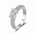 Emerald and Radiant Cut Moissanite Side Stone Engagement Ring with CZ in rhodium-plated S925 sterling silver on clean white background