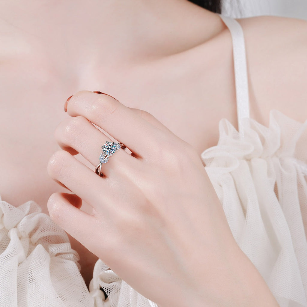 Round Moissanite Side Stone Engagement Ring with CZ worn on hand to show scale, band width, and ring profile