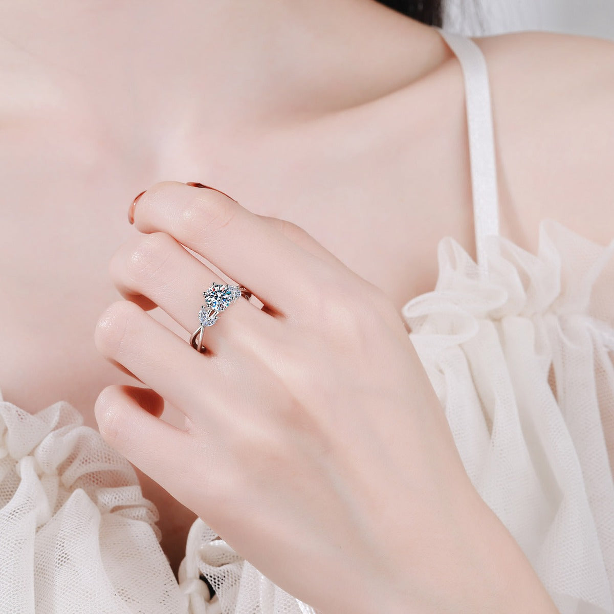 Round Moissanite Side Stone Engagement Ring with CZ worn on hand to show scale, band width, and ring profile