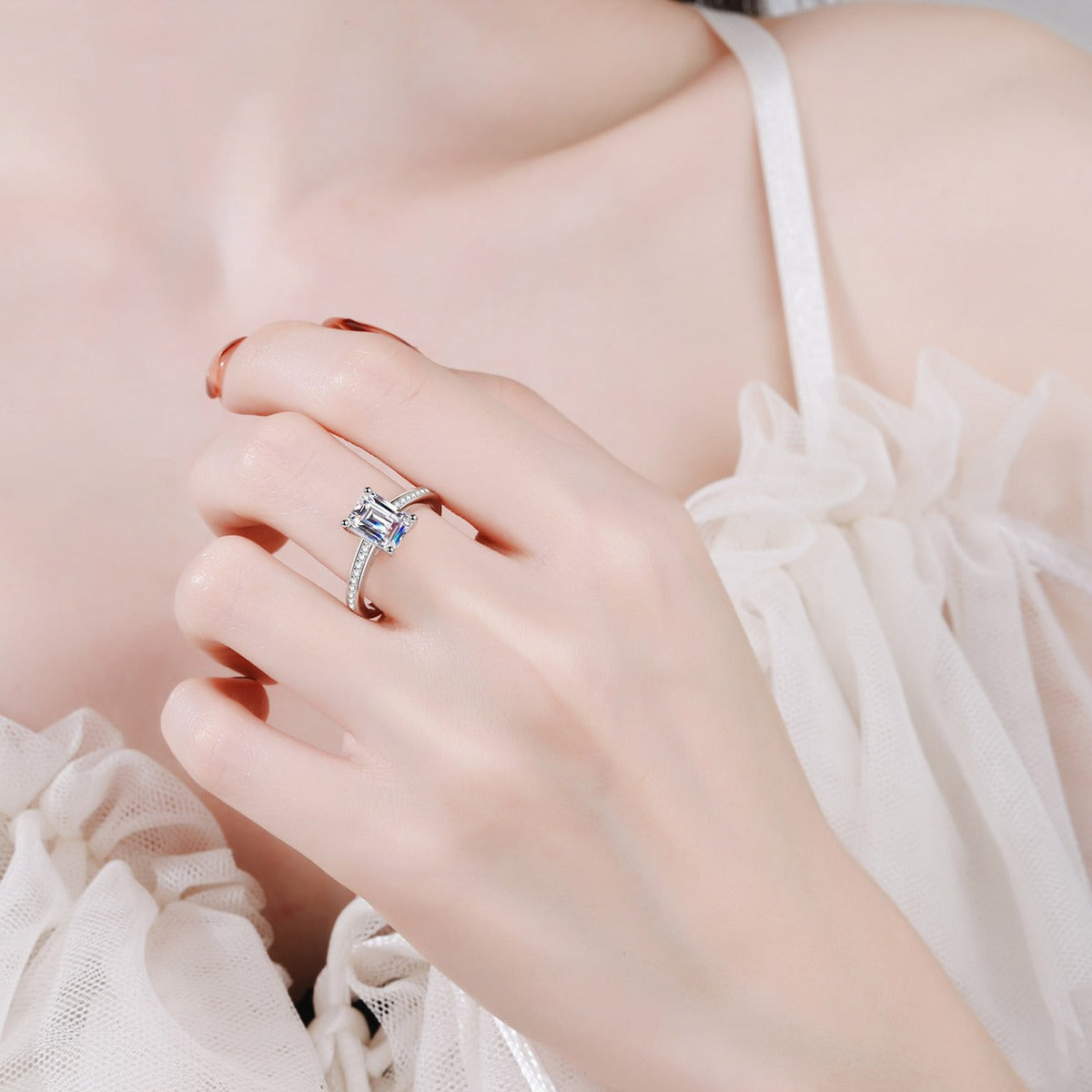 Emerald and Radiant Cut Moissanite Ring with CZ worn on hand to show scale, band width, and ring profile