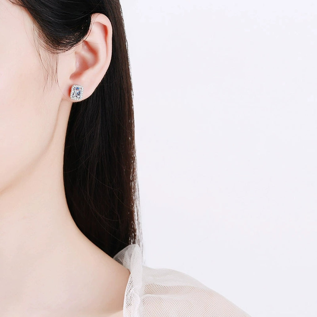 Emerald and Radiant Moissanite Stud Earrings with CZ in Rhodium-Plated S925 sterling silver worn on ear by model showing scale, placement, and stud earrings styling